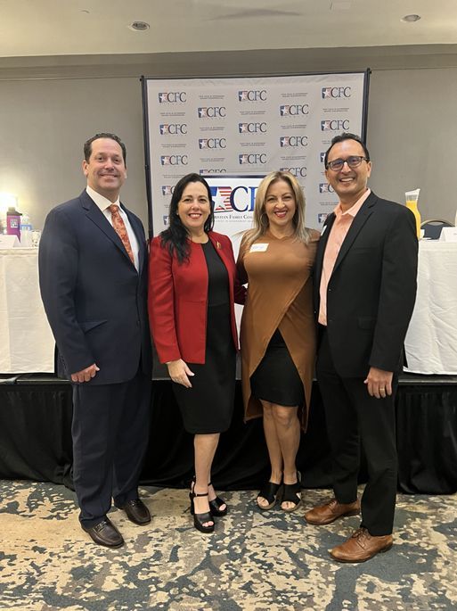 A group of people are posing for a picture in a room