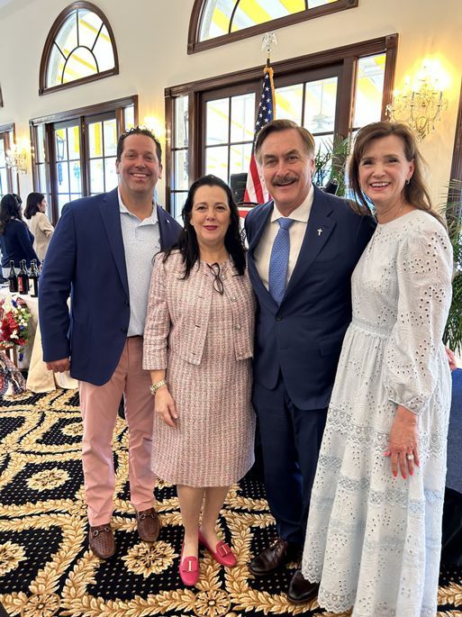 A group of people are posing for a picture in a room
