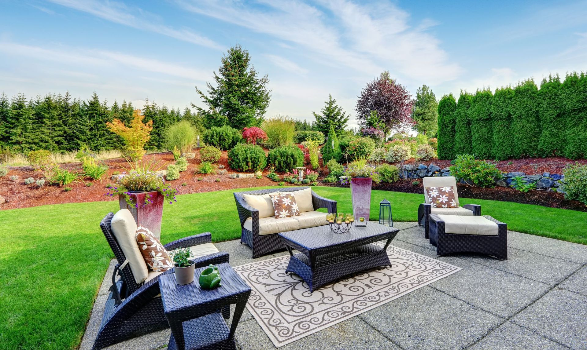 Patio with a lush green lawn and garden.