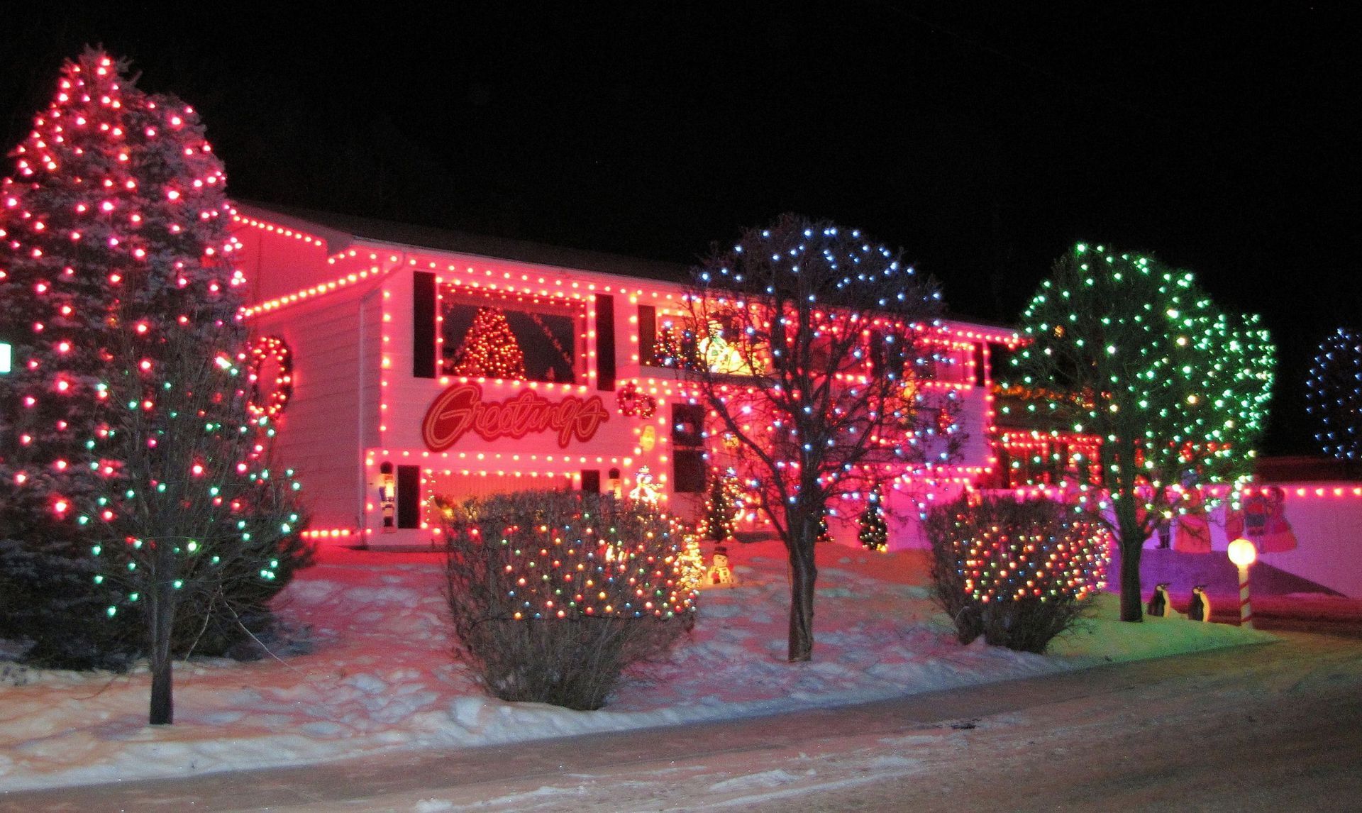 A house covered in bright Christmas lights. A house covered in bright Christmas lights.