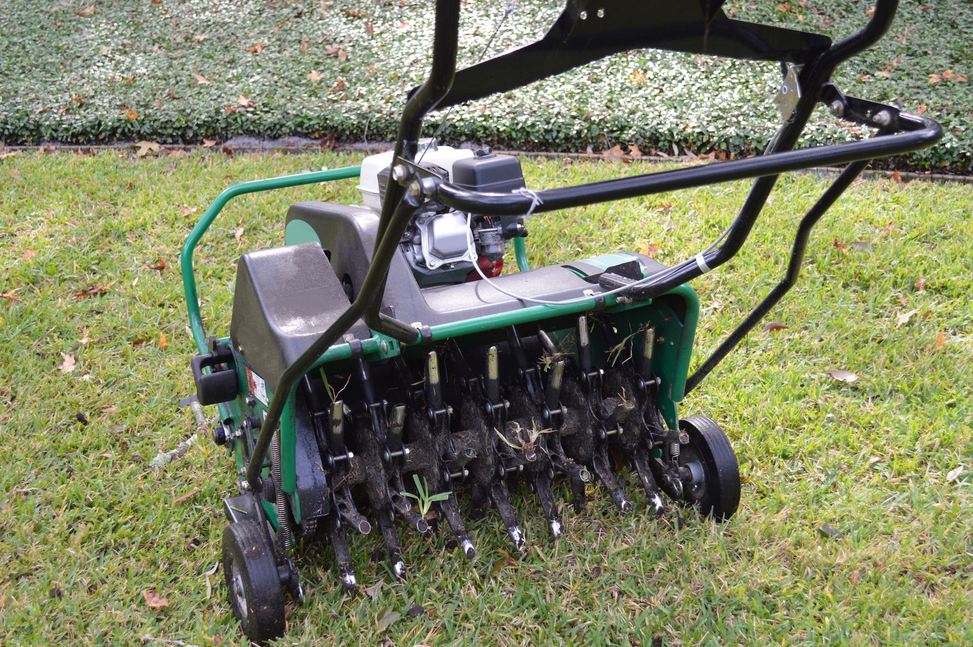 Green lawn aerator on grass