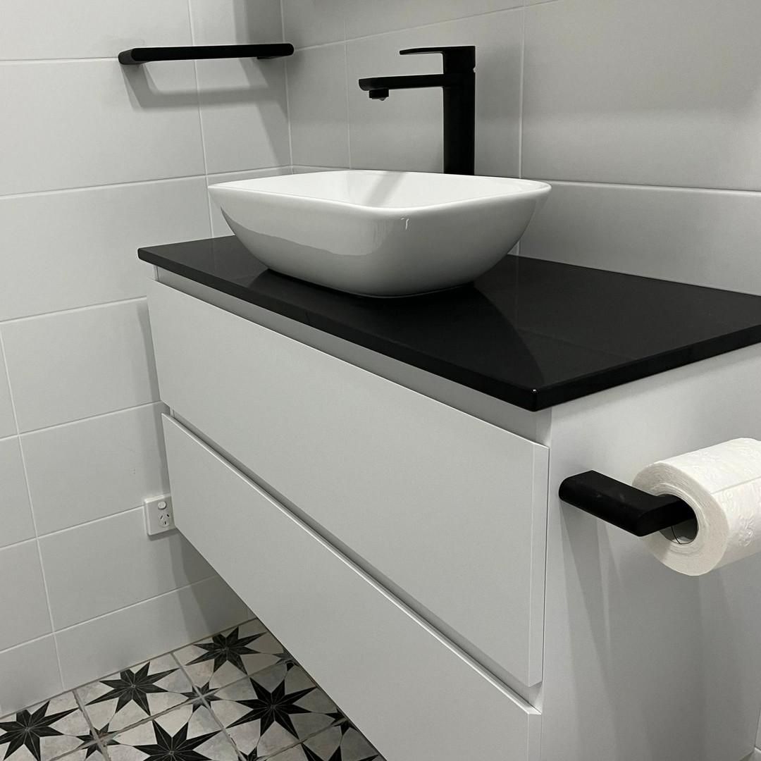 A Bathroom Sink with A Black Counter Top and A Black Faucet — Bowral Bathrooms in Exeter, NSW