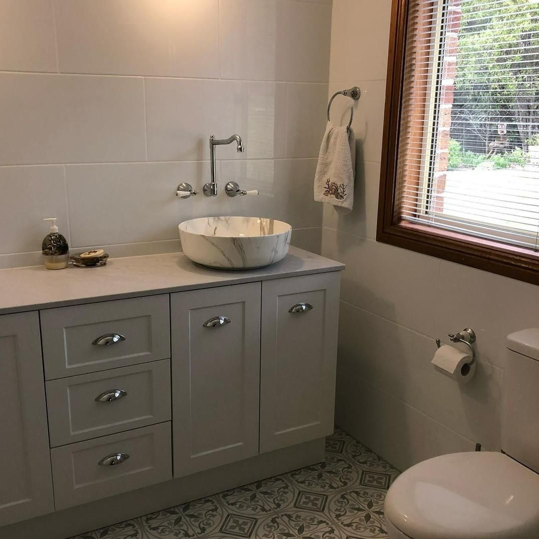A Bathroom with A Sink, Toilet and Window — Bowral Bathrooms in Moss Vale, NSW