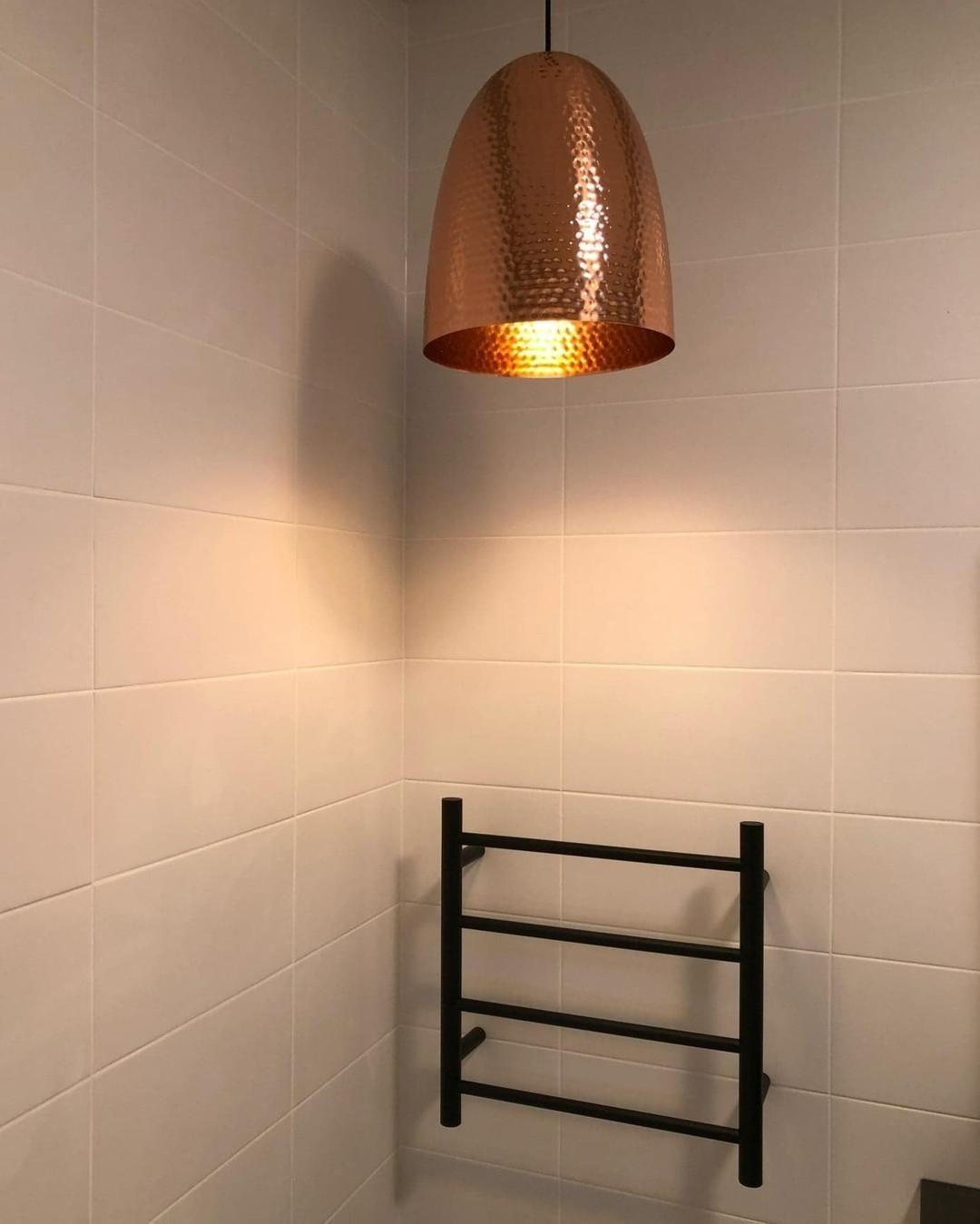 A Bathroom with A Towel Rack and A Copper Light Hanging from The Ceiling — Bowral Bathrooms in Moss Vale, NSW