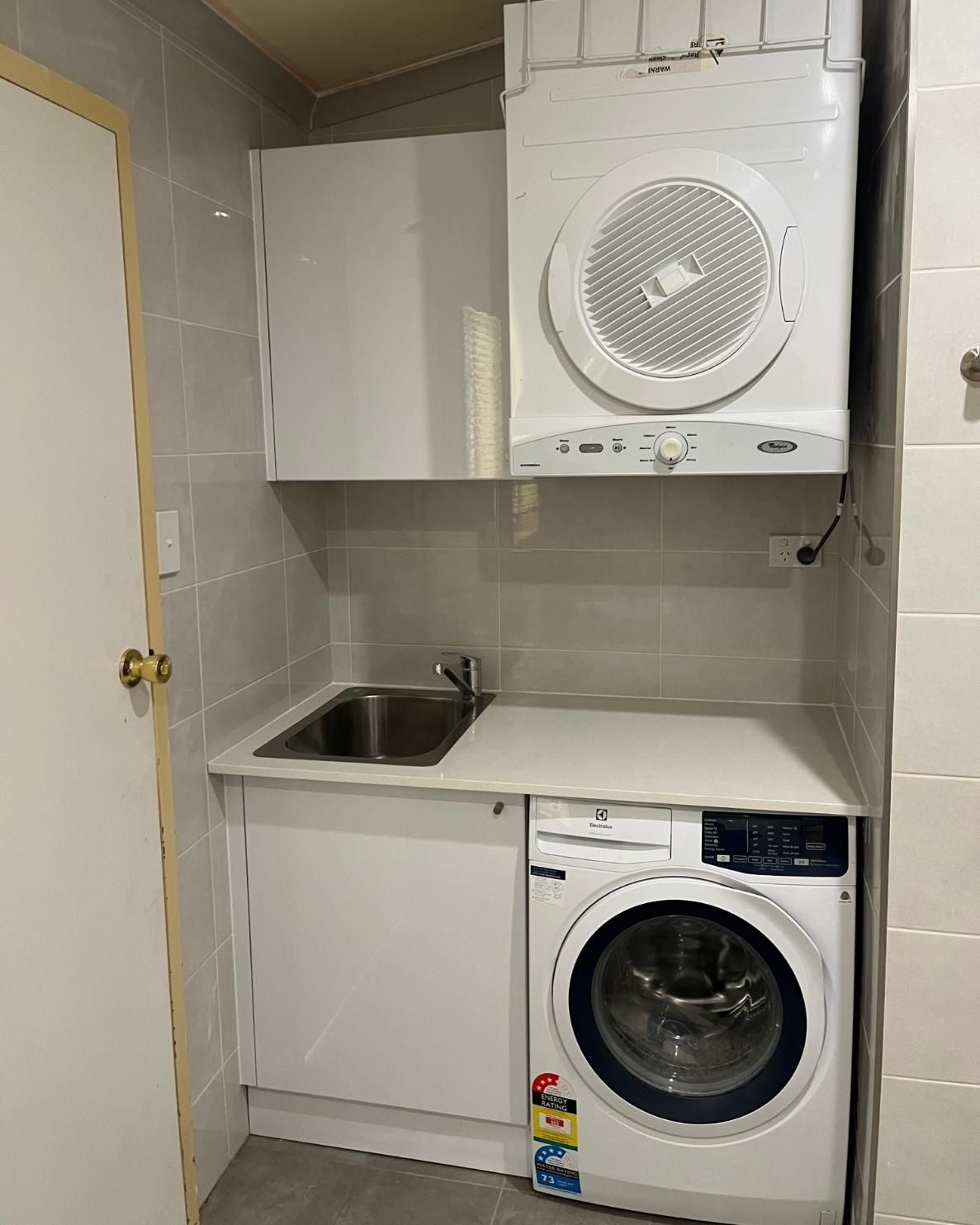 A Laundry Room with A Washer and Dryer and A Sink — Bowral Bathrooms in Exeter, NSW