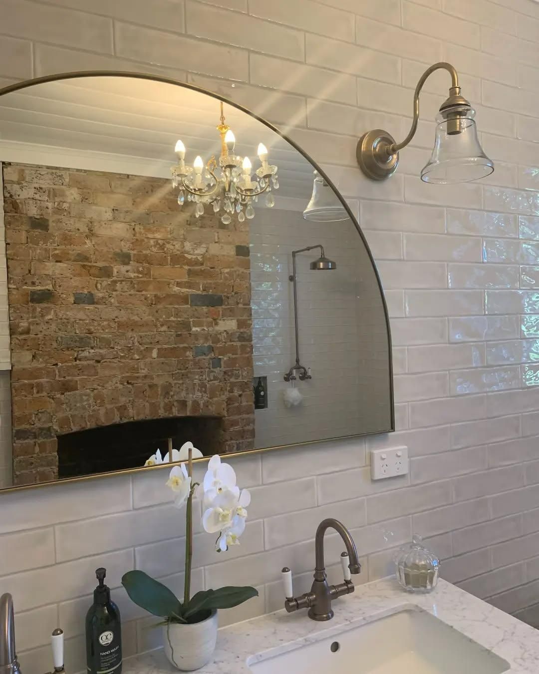 A Bathroom with A Sink, Mirror and Chandelier — Bowral Bathrooms in Exeter, NSW