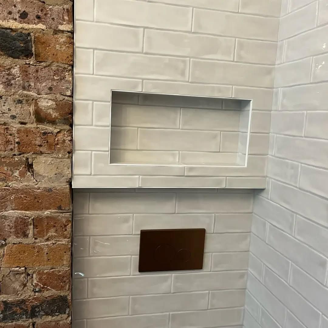 A Bathroom with White Tiles and A Brick Wall — Bowral Bathrooms in Bowral, NSW