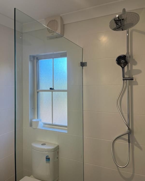 A Bathroom with A Toilet, Shower, and Window — Bowral Bathrooms in Exeter, NSW