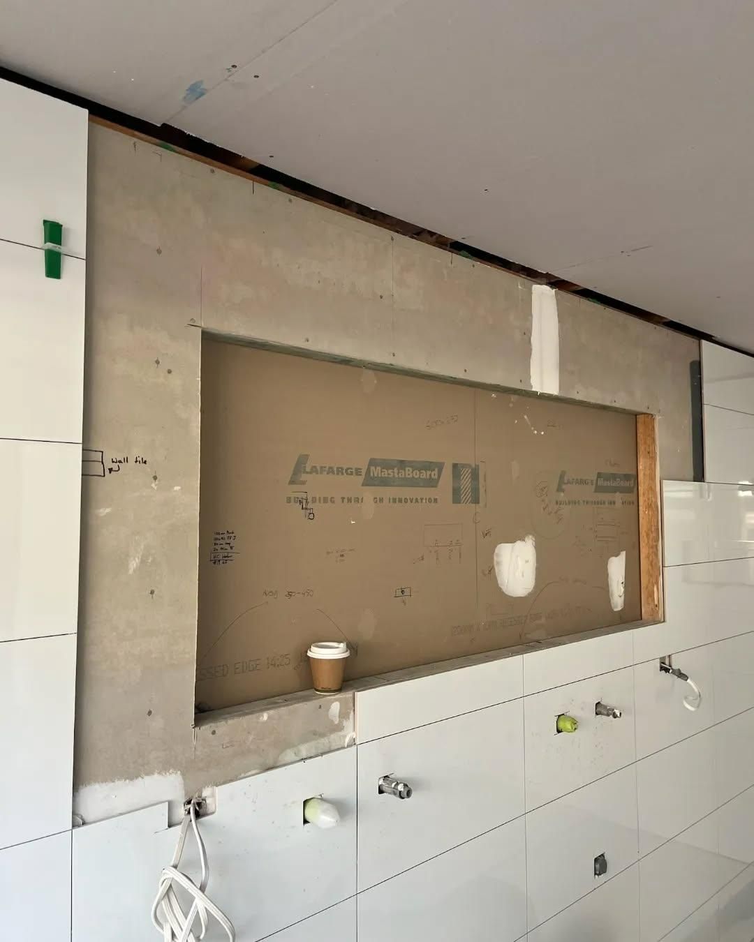 A Bathroom with White Tiles and A Window in The Wall — Bowral Bathrooms in Exeter, NSW
