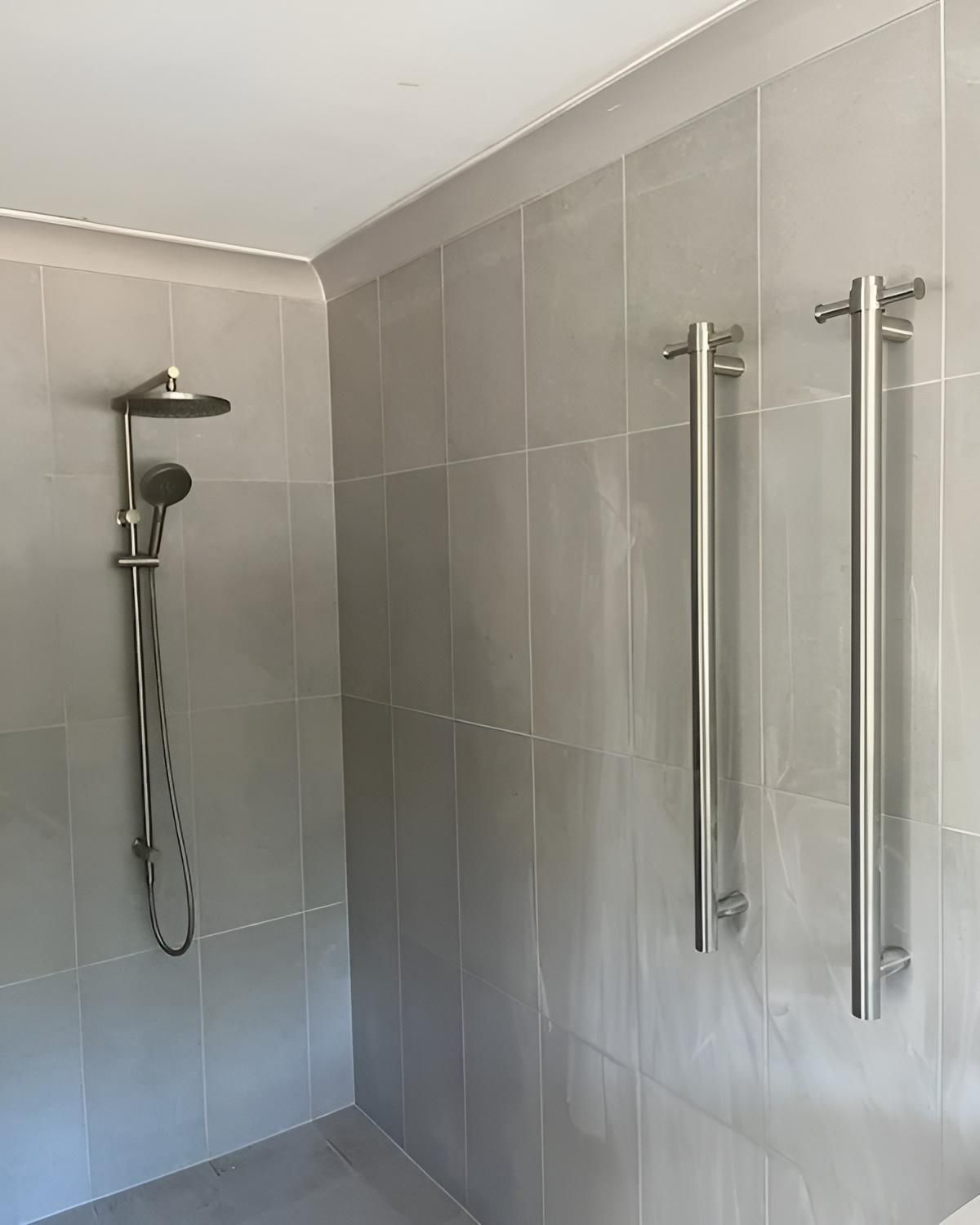 A Bathroom with A Shower Head and Towel Racks on The Wall — Bowral Bathrooms in Exeter, NSW