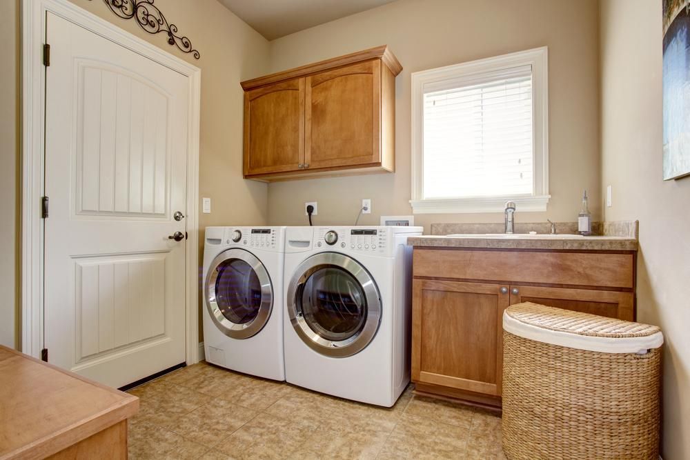 A Laundry Room with A Washer and Dryer and A Sink — Bowral Bathrooms in Exeter, NSW