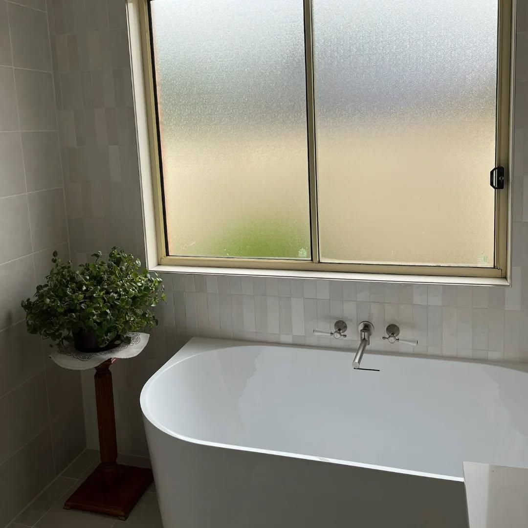 A Bathroom with A Bathtub and A Window — Bowral Bathrooms in Exeter, NSW