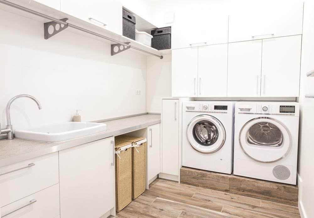 A Laundry Room with Two Washing Machines and A Sink — Bowral Bathrooms in Exeter, NSW