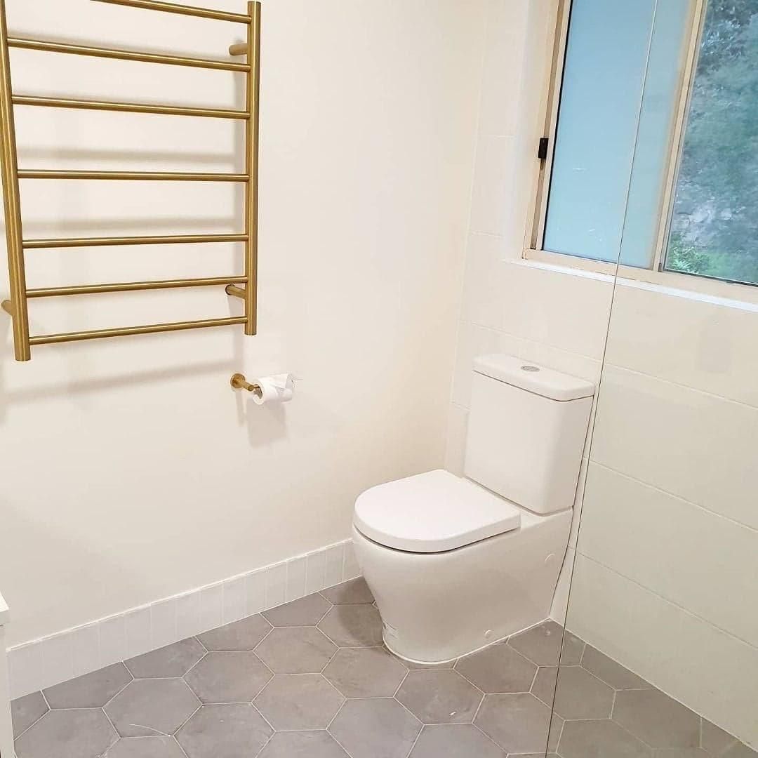 An After Image of Bathroom with A Toilet, Towel Rack and Window — Bowral Bathrooms in Exeter, NSW