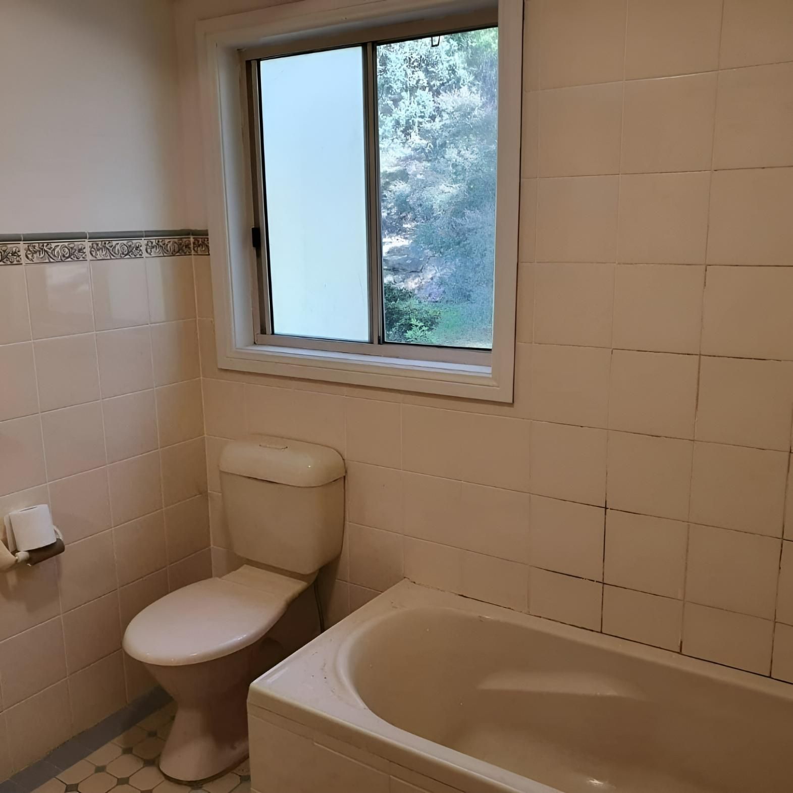 A Before Image of Bathroom with A Toilet a Tub and A Window — Bowral Bathrooms in Exeter, NSW