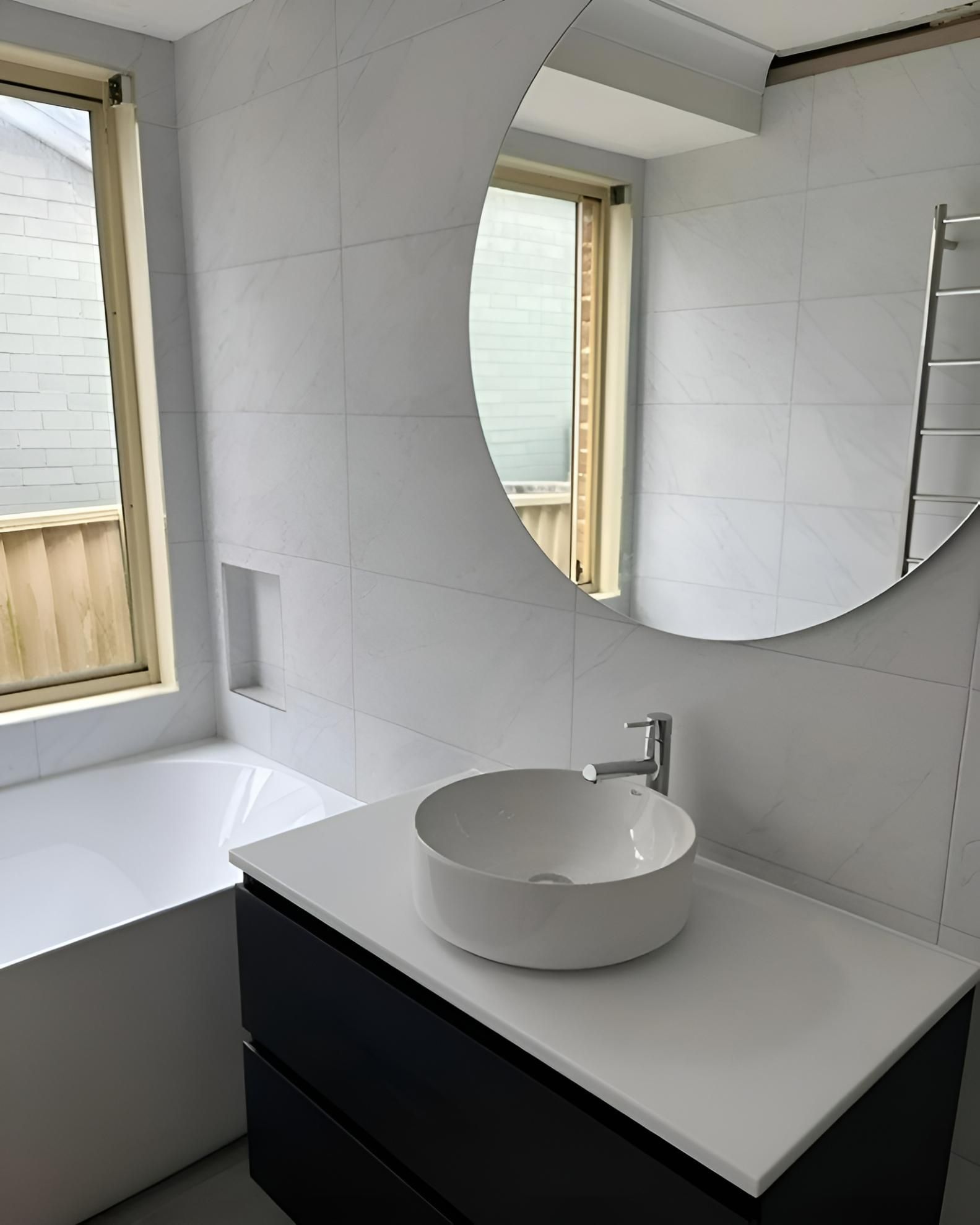 An After Image of Bathroom with A Sink and A Round Mirror — Bowral Bathrooms in Exeter, NSW