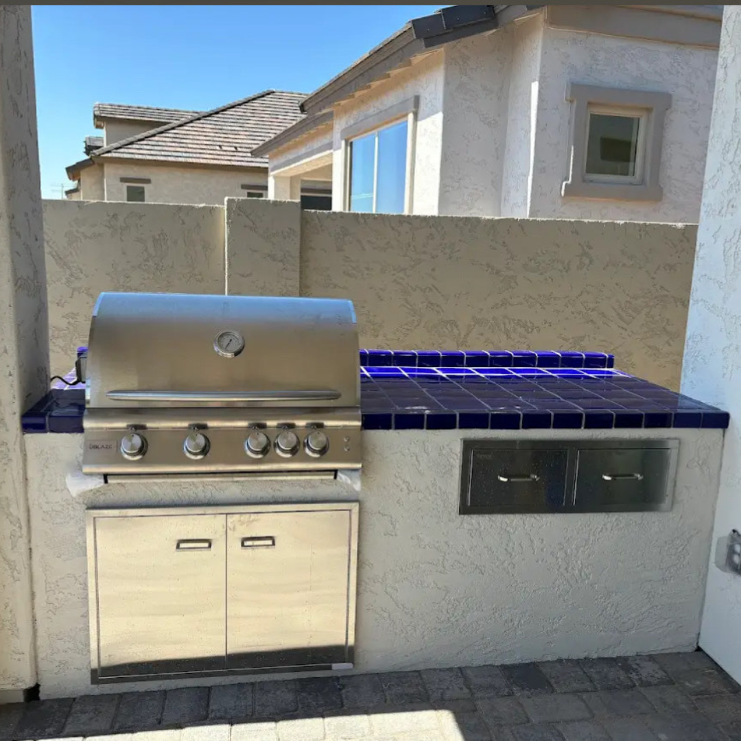 A stainless steel grill is built into a wall