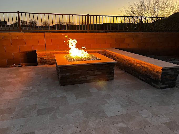 There is a fire pit in the middle of the patio.