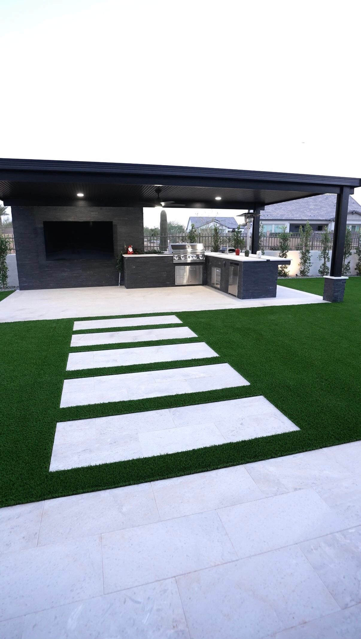 A patio with a covered area and a walkway leading to it.