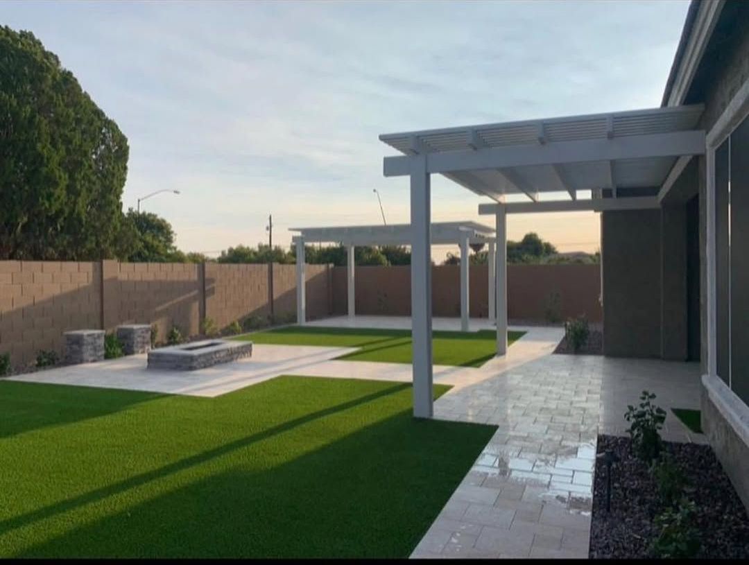A backyard with a pergola and a fire pit