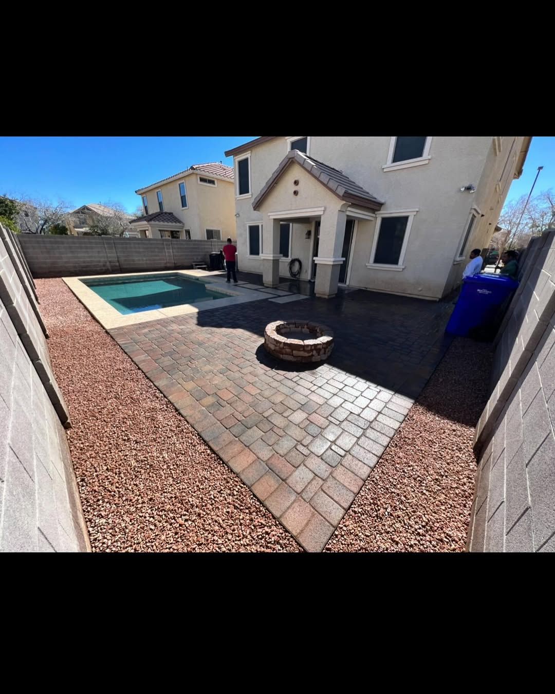 A house with a pool and a fire pit in the backyard.