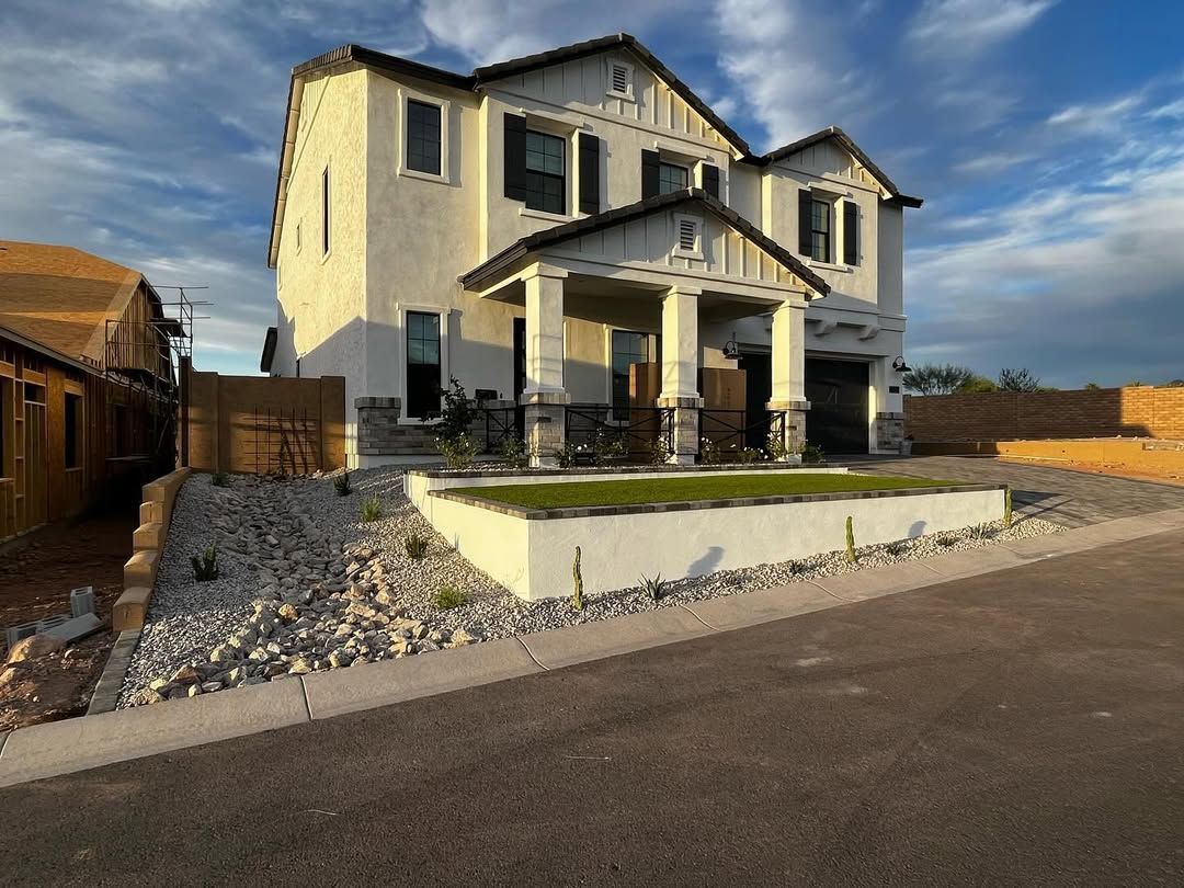 A large white house is sitting on the side of a road.