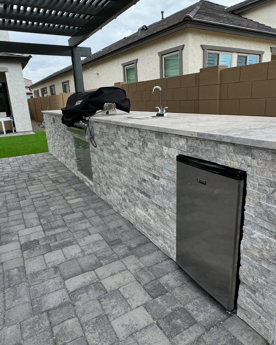 There is a stainless steel dishwasher in the backyard.