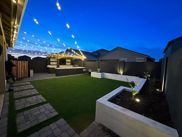 A backyard with a lot of lights hanging from the ceiling