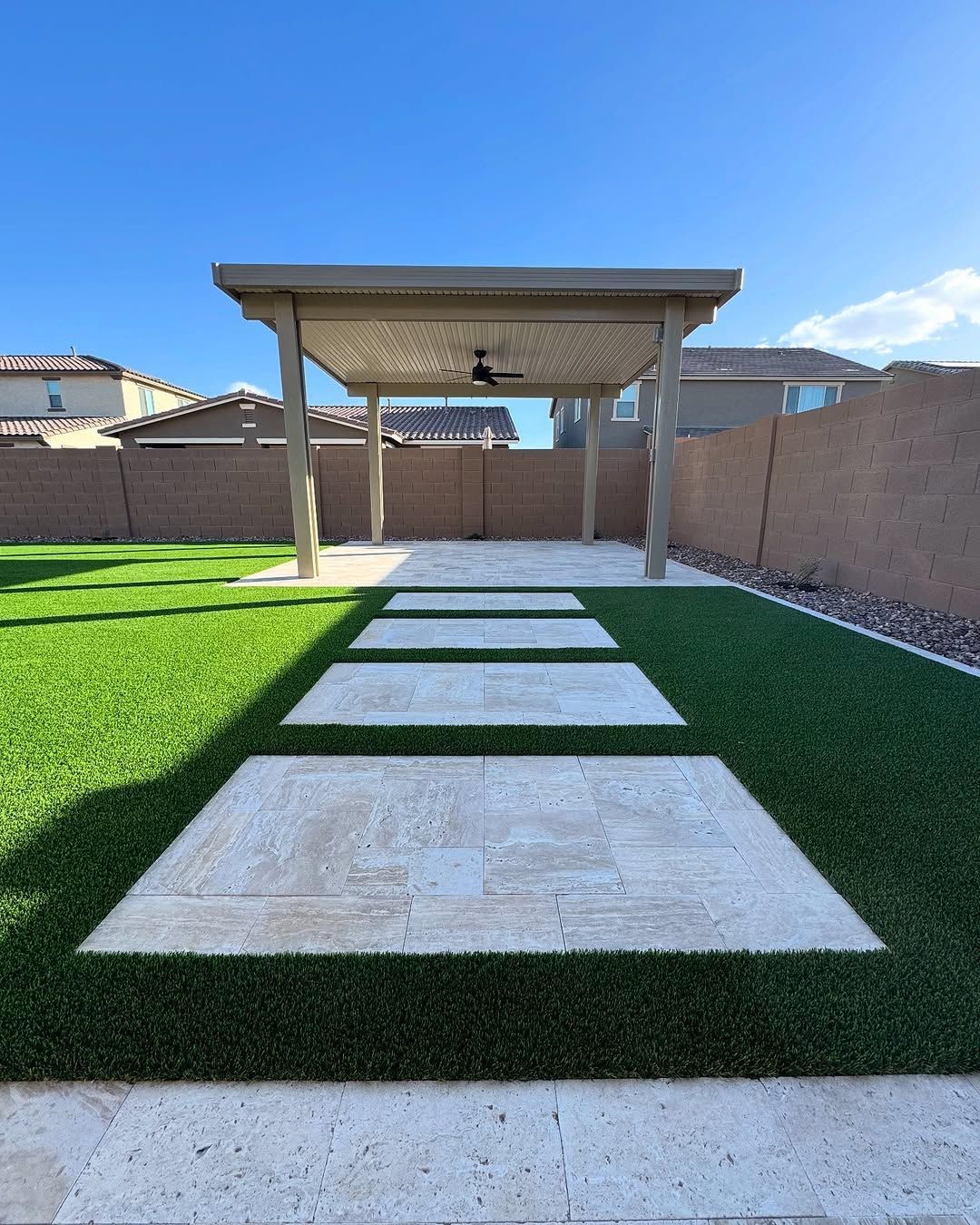 A backyard with a pergola and steps leading to it