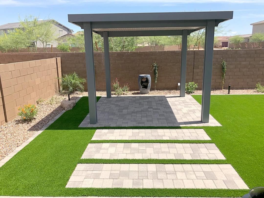 There is a pergola in the middle of the backyard.