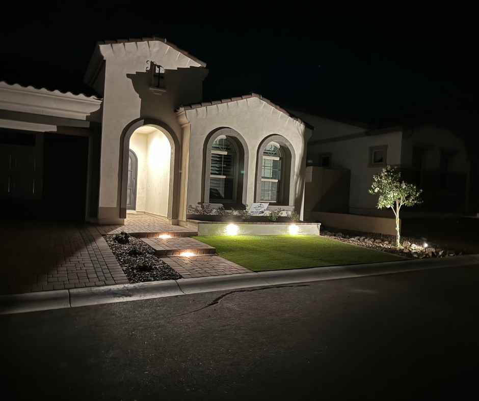 The front of a house is lit up at night.