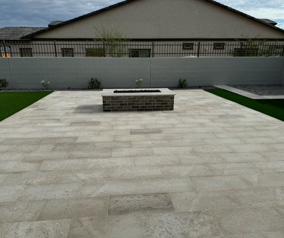 A patio with a fire pit in the middle of it