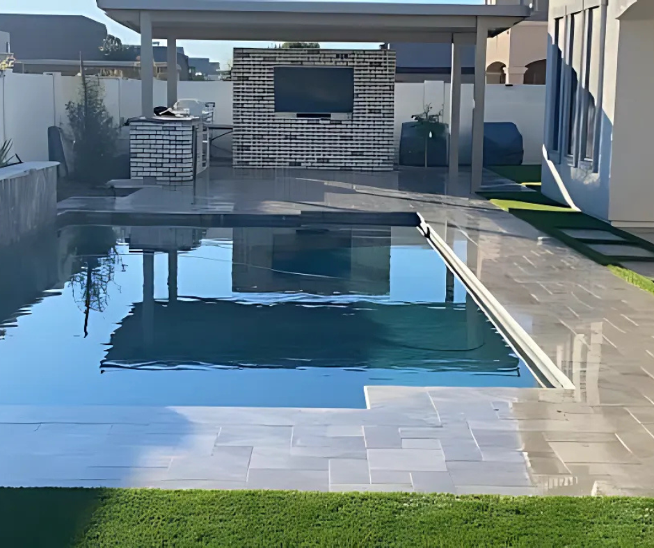 A large swimming pool in front of a house
