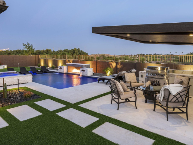 A backyard with a swimming pool and patio furniture