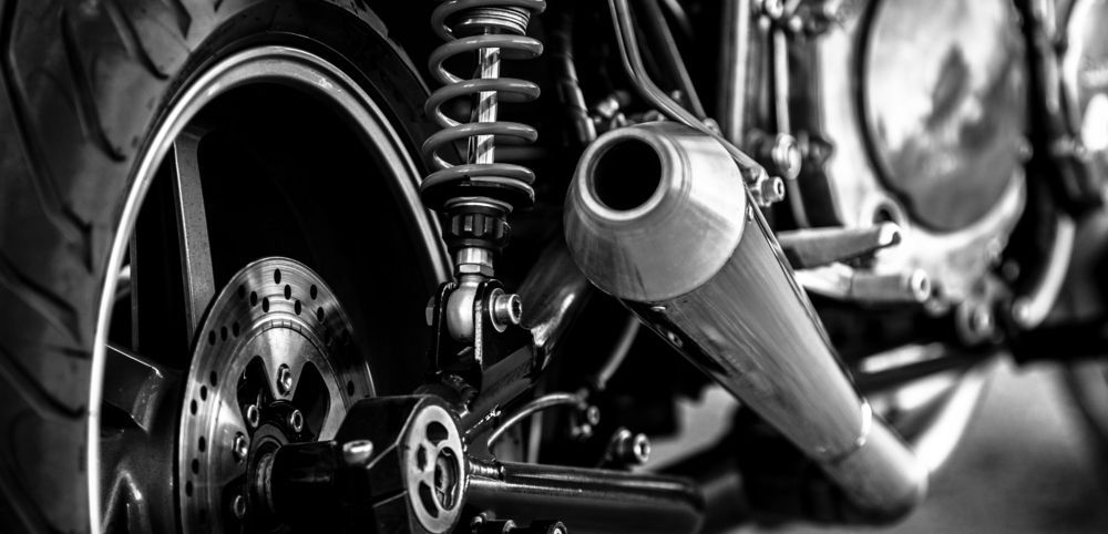 Black and White Photo of a Motorcycle With a Shock Absorber and Exhaust Pipe — 365 Towing Taree in Wingham, NSW