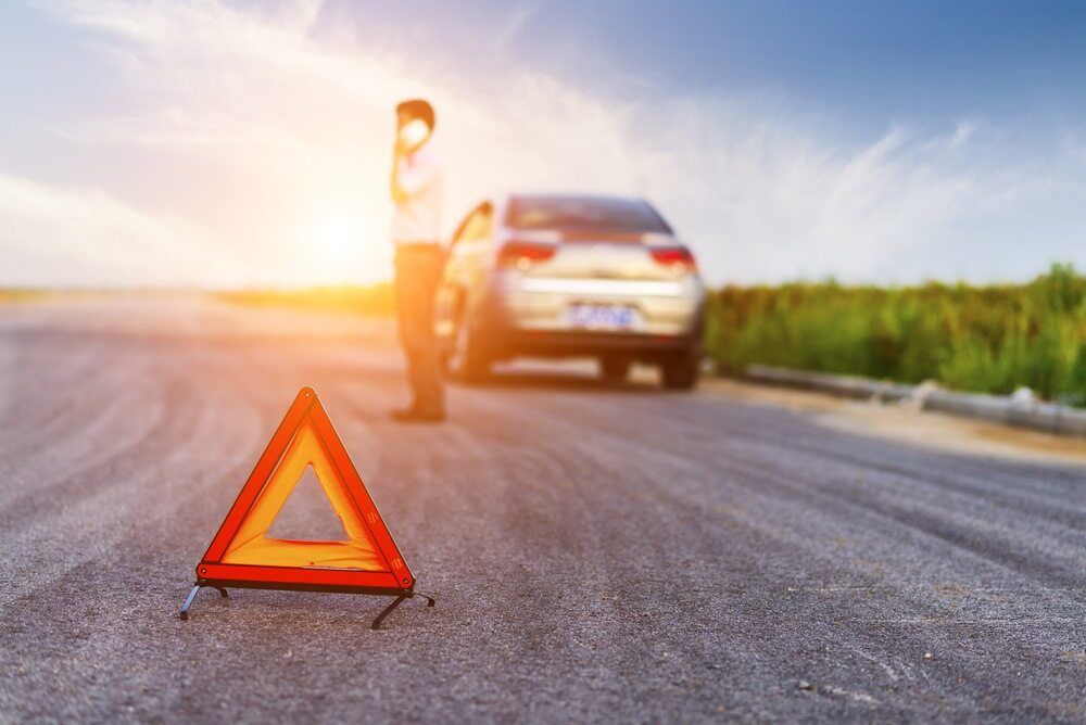 Man is Standing Next to a Broken Down Car on the Side of the Road — 365 Towing Taree in Wingham, NSW