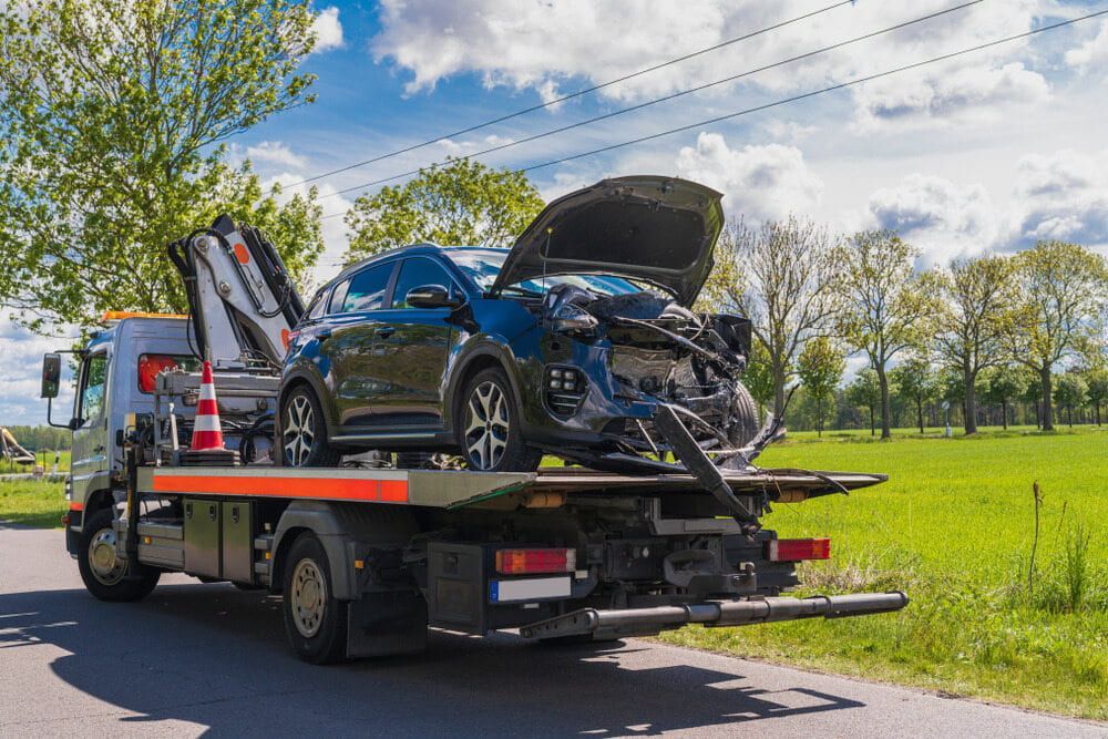 Tow Truck With a Wrecked Car on the Back of It — 365 Towing Taree in Wingham, NSW