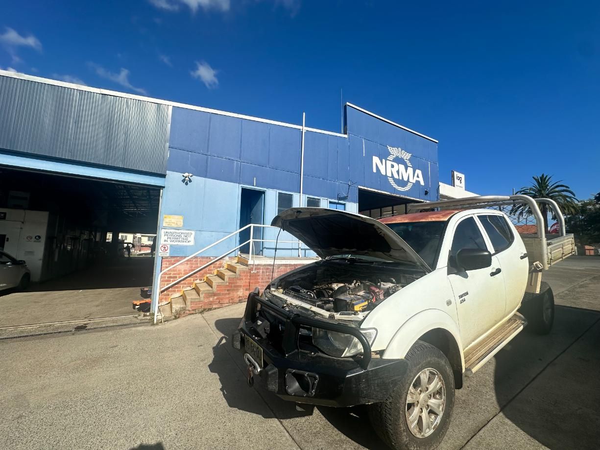 White Truck With the Hood Up is Parked in Front of a Building — 365 Towing Taree in Coffs Harbour, NSW