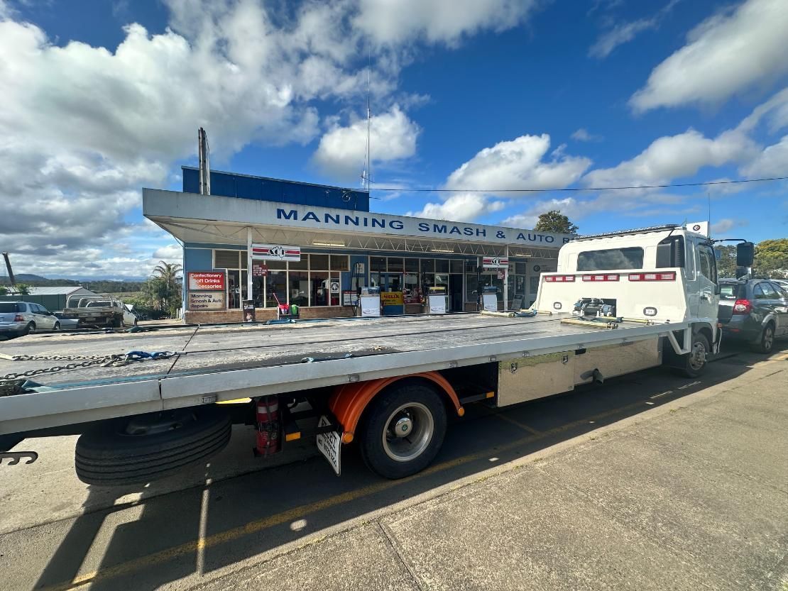 Tow Truck is Parked in Front of a Building — 365 Towing Taree in Wingham, NSW