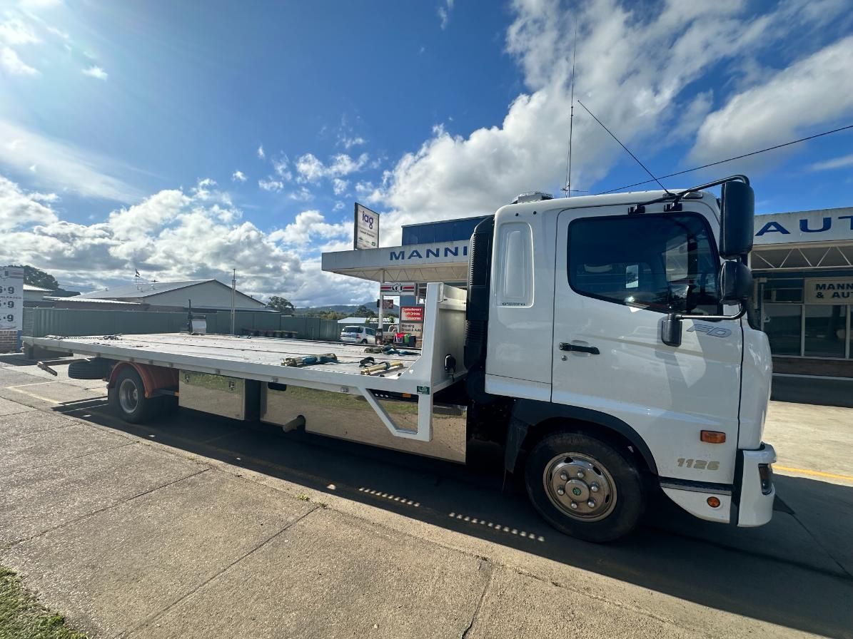 White Tow Truck is Parked on the Side of the Road — 365 Towing Taree in Coffs Harbour, NSW