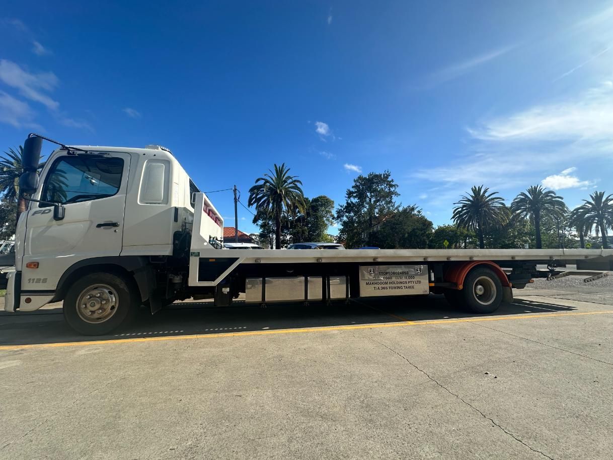 White Tow Truck is Parked on the Side of the Road — 365 Towing Taree in Newcastle, NSW
