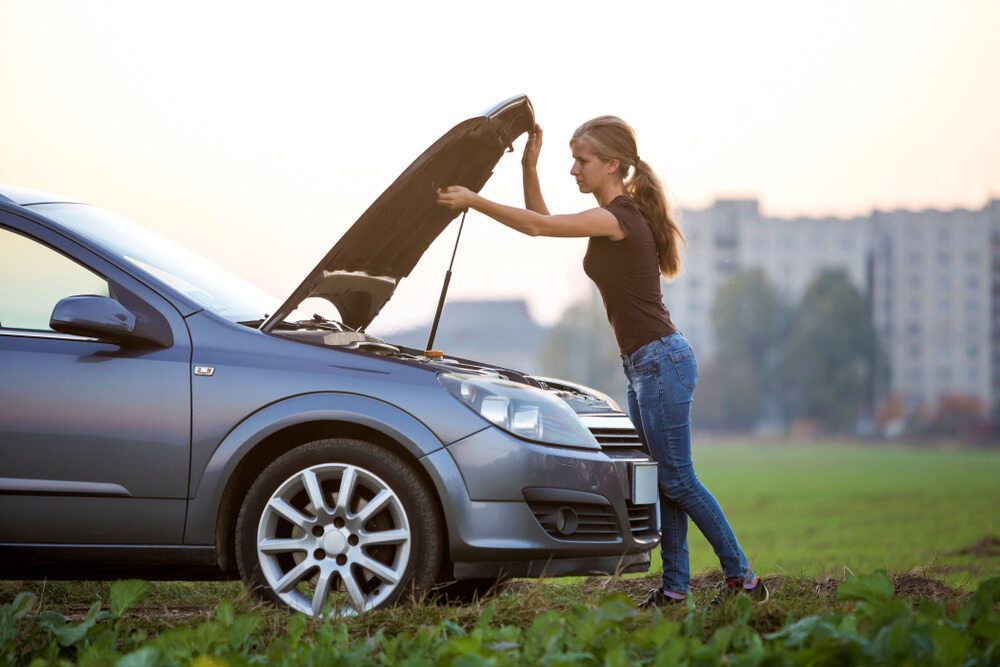 Woman is Opening the Hood of Her Broken Down Car — 365 Towing Taree in Oldbar, NSW