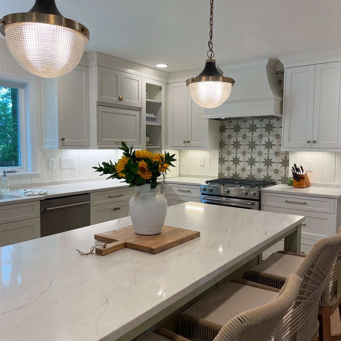 A kitchen with a vase of flowers on the counter