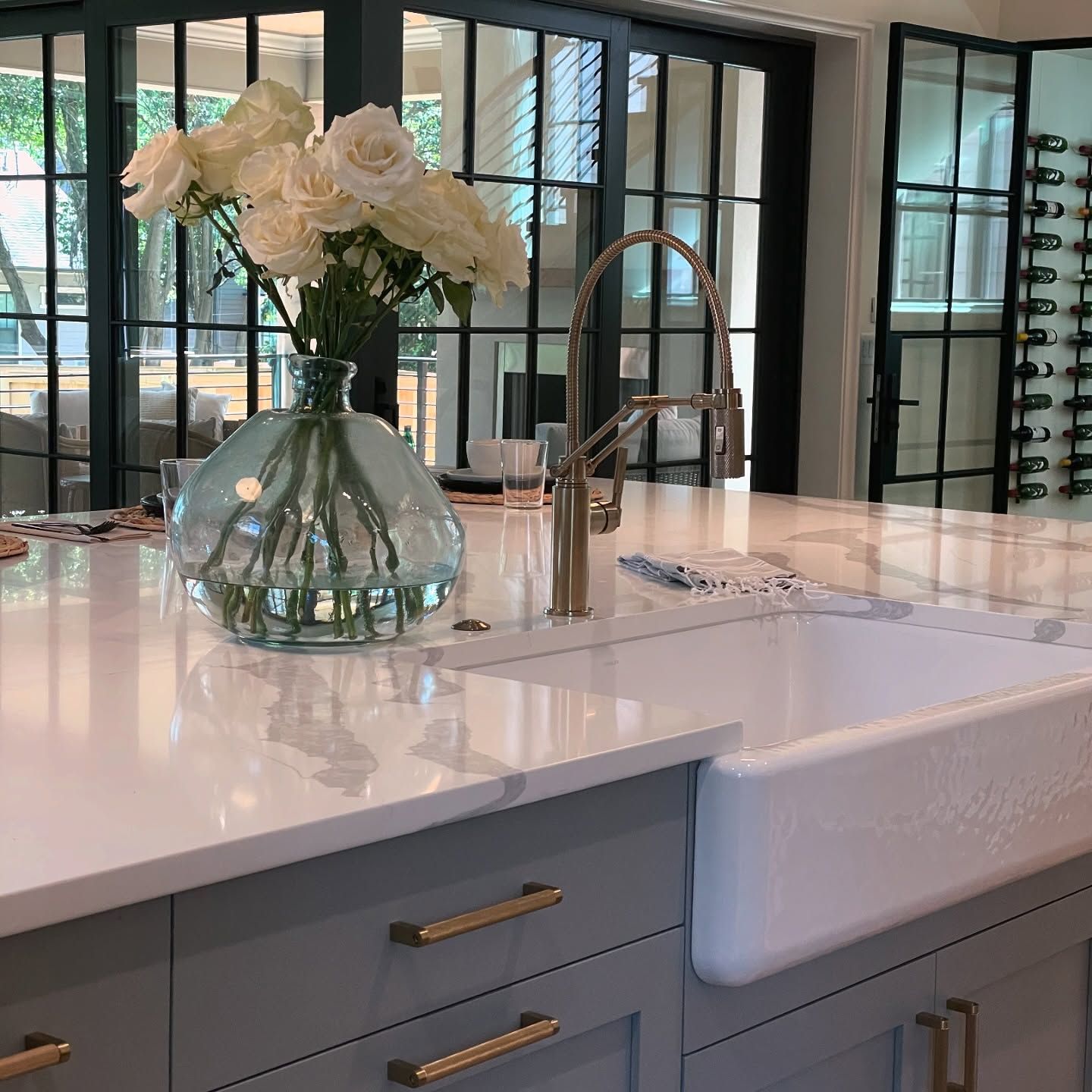 A kitchen counter with a vase of flowers on it