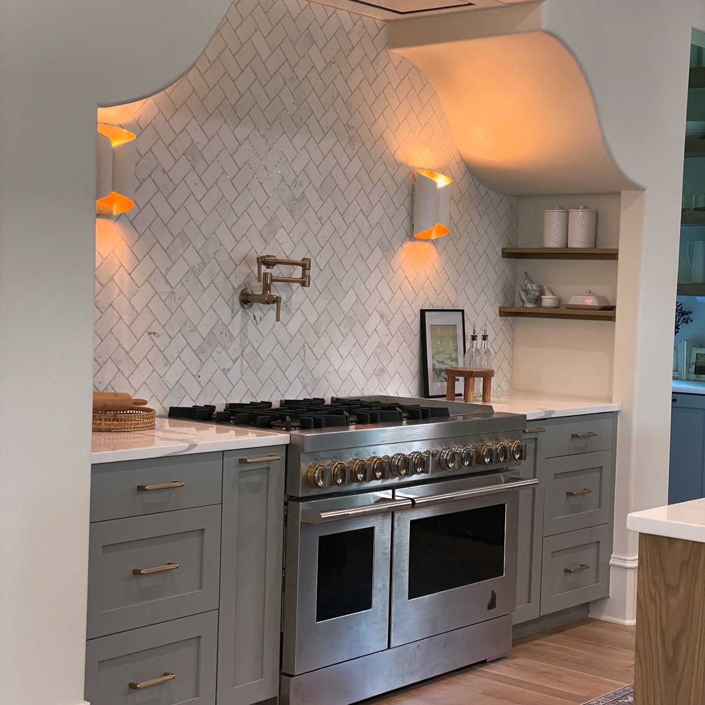 A kitchen with stainless steel appliances and gray cabinets