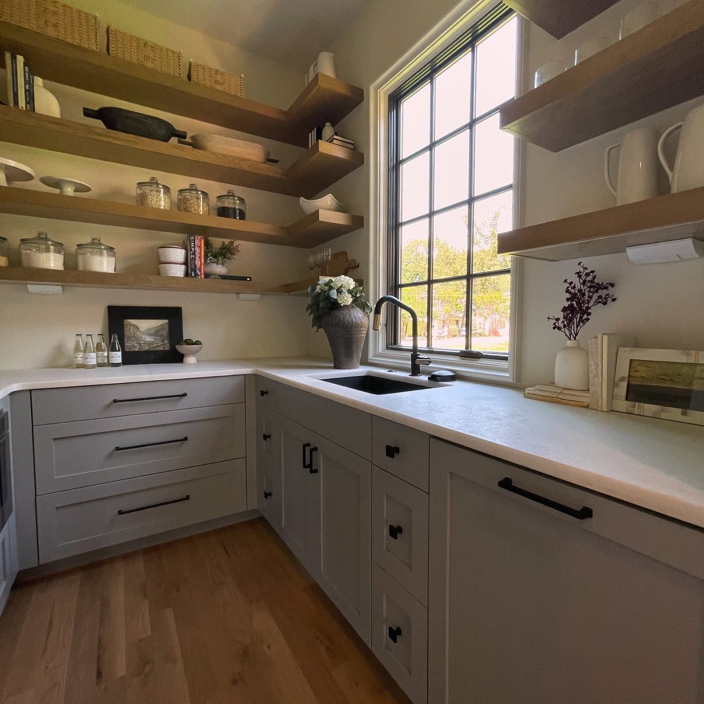 A kitchen with a sink and lots of shelves