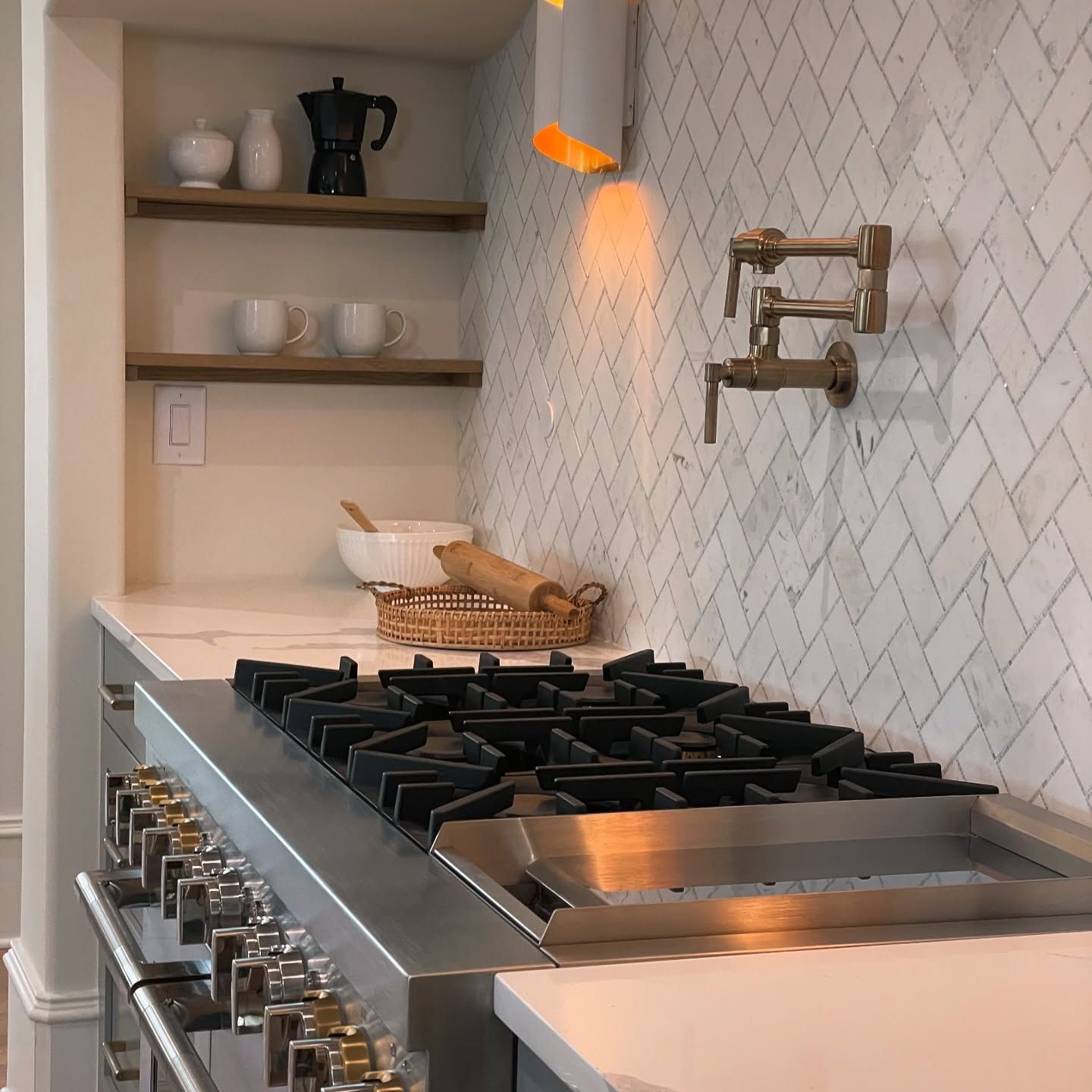 A kitchen with a stove top oven and shelves
