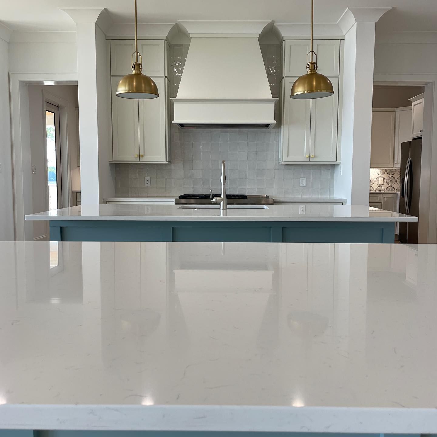 A kitchen with white cabinets and a white counter top