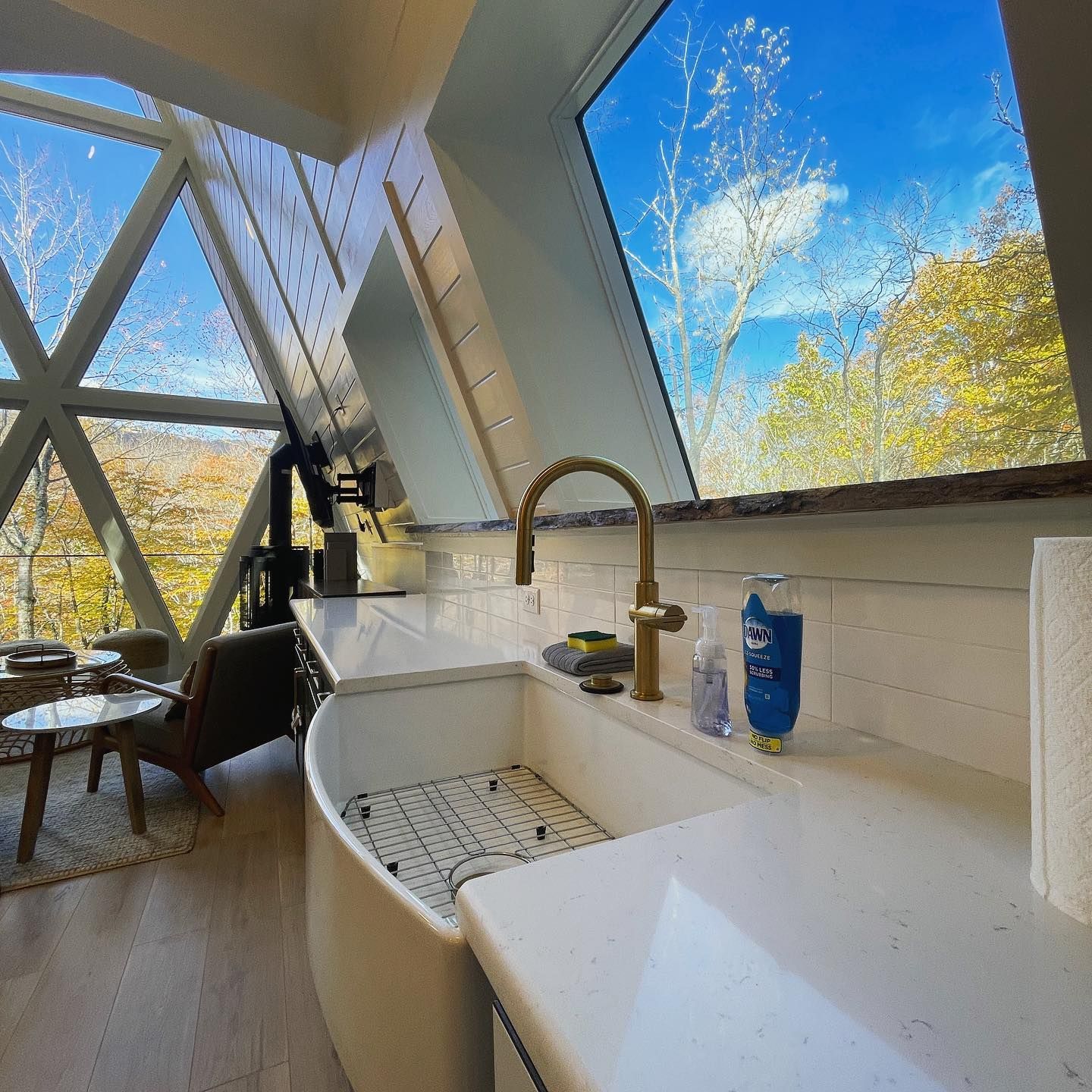 A kitchen with a sink and a large window