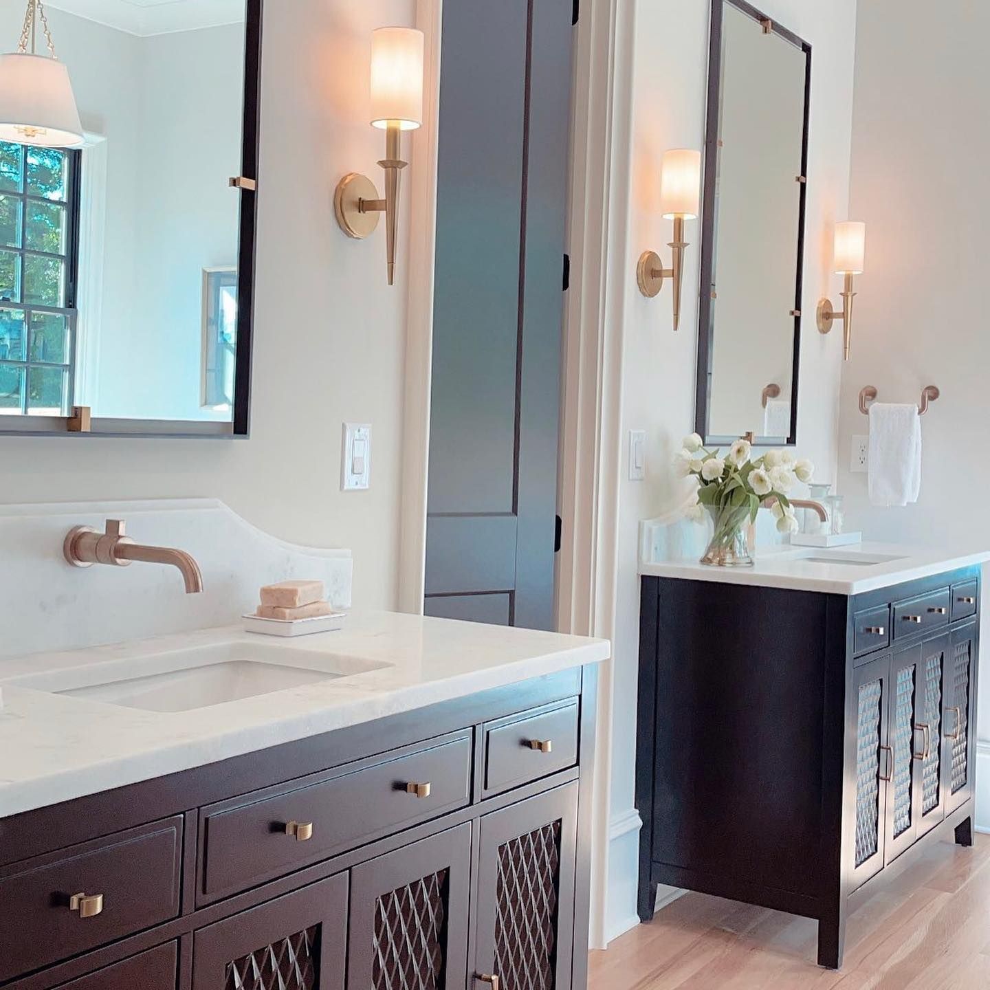 A bathroom with two sinks and a mirror